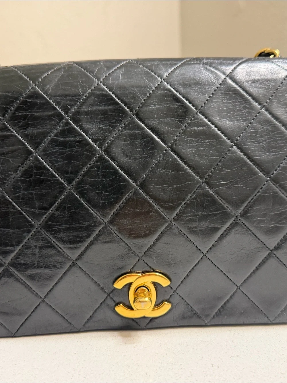 CHANEL Black Quilted Shoulder Bag with Gold CC Lock